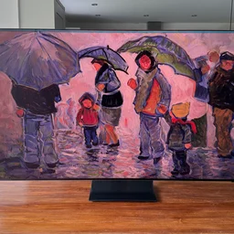 The Samsung R95H Micro LED TV on a wooden table in a conservatory displaying digital artwork of people with umbrellas