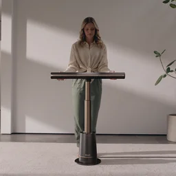 an image of a woman standing behind the Shark TurboBlade fan