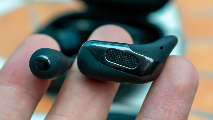 Shokz OpenFit 2 Plus earbud, in hand, bottom view