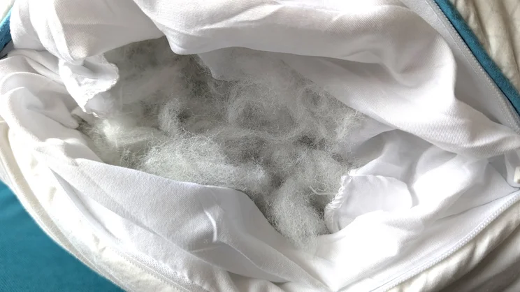 A closeup of the Simba Aerodown pillow, umzipped to show its fibre filling