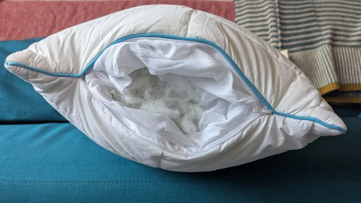 The Simba Aerodown pillow unzipped, showing its fibre filling