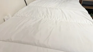 The Slumberdown Sleep Soundly Climate Control mattress topper on a mattress