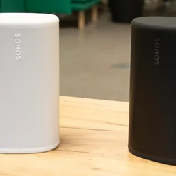 The white and black Sonos Play speakers next to each other on a wooden desk