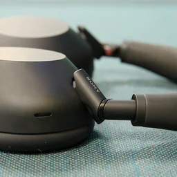 The Sony WH-1000XM6 headphones pictured on a green textured surface