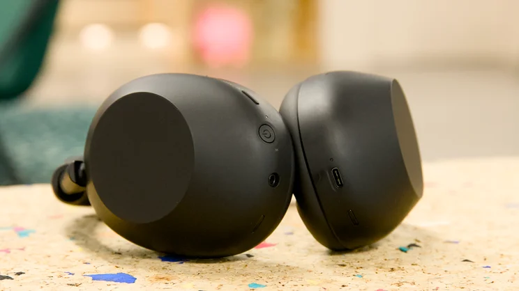 The Sony WH-1000XM6 pictured on their side from the bottom, on a cork surface