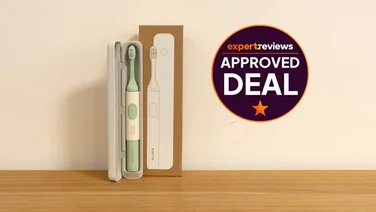 The Suri 2.0 electric toothbrush on a wooden bench, alongside its box. A badge to the right reads "Expert Reviews Approved Deal"