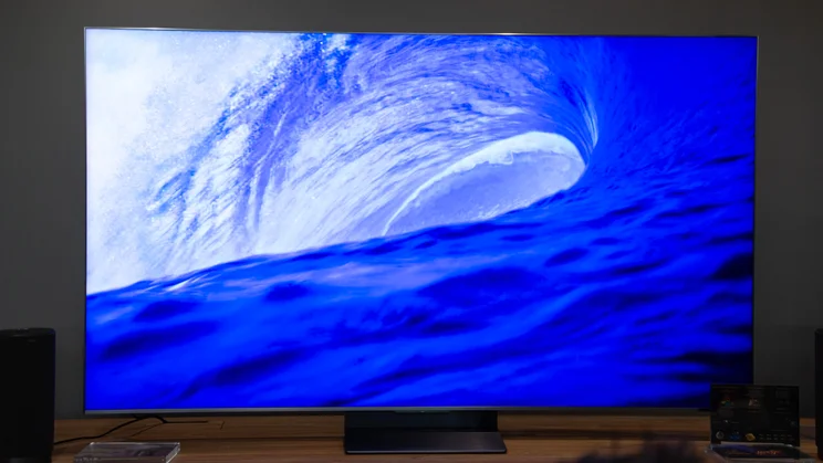 The TCL C8L SQD Mini LED TV displaying a large blue wave