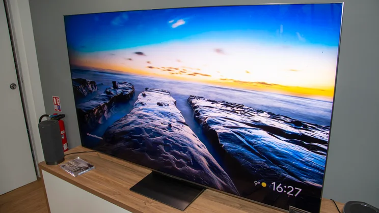 The TCL C8L SQD Mini LED TV displaying a Google TV screensaver