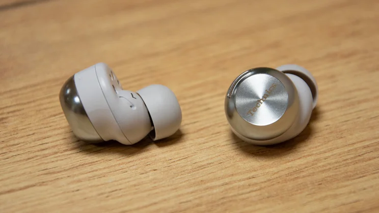 The Technics EAH-AZ100 wireless earbuds with one earbud turned in to show the ergonomic nozzle