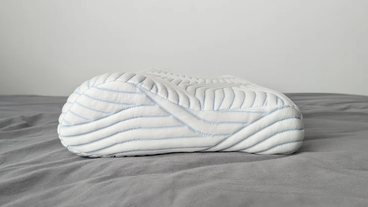 The Tempur Original SmartCool Pillow on a bed, side view