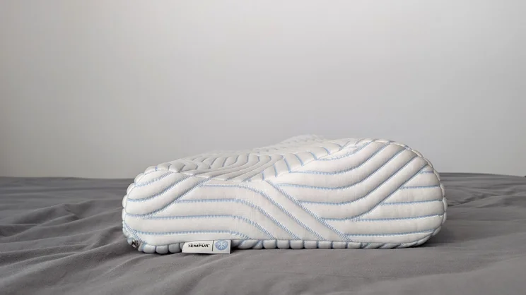 The Tempur Original SmartCool Pillow on a bed, side view