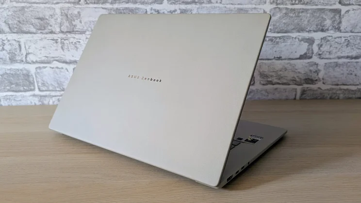 The Asus Zenbook A16, open, pictured from the rear left quarter