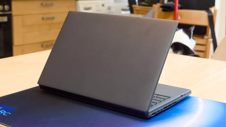 The Asus Zenbook Duo 2026, in laptop mode, pictured from the rear left quarter, half open