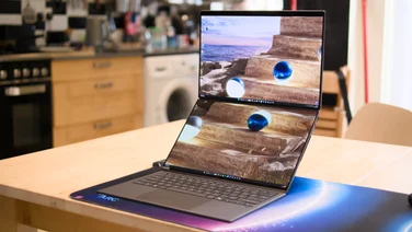 The Asus Zenbook Duo 2026, open fully on a kitchen table