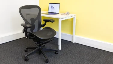 Herman Miller Aeron office chair at a desk with open laptop
