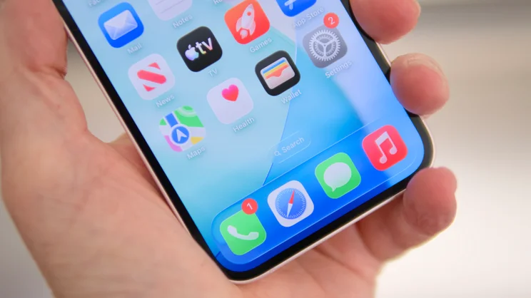 The bottom half of the Apple iPhone 17e's display pictured held in a hand