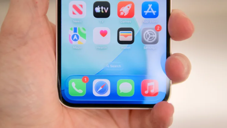 The bottom half of the Apple iPhone 17e's display pictured held in a hand