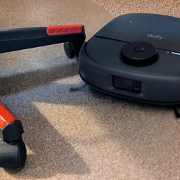 The Eufy Omni C28 pictured cleaning around the legs of an office chair