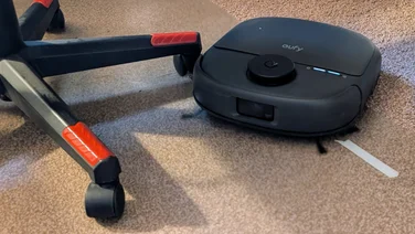 The Eufy Omni C28 pictured cleaning around the legs of an office chair