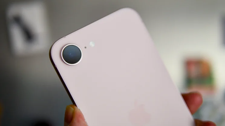 The rear of Apple iPhone 17e in soft pink, pictured with a focus on the camera