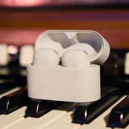 The Sony WF-1000XM6 in their charging case on a music keyboard