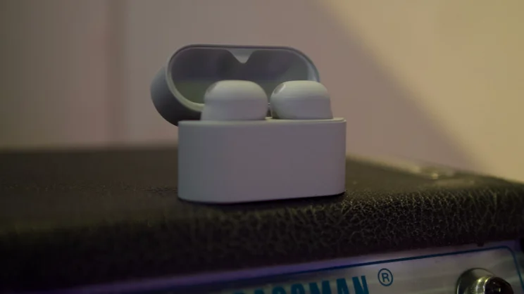 The Sony WF-1000XM6 in their charging case on top of a guitar amplifier