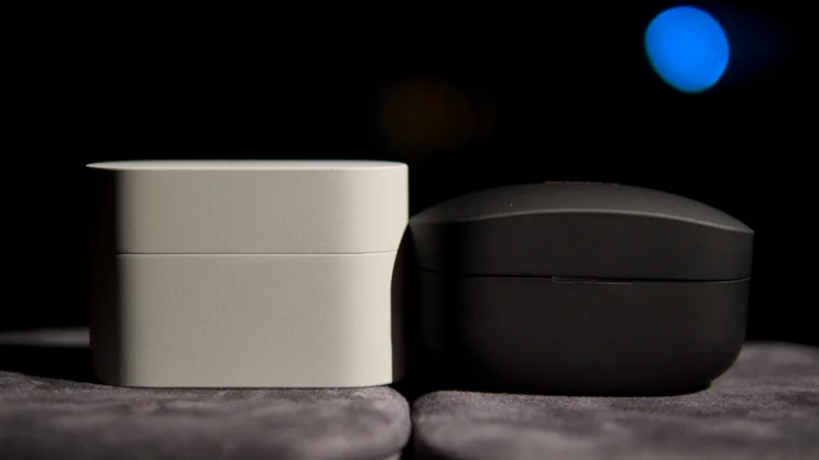 The Sony WF-1000XM6's charging case, next to the WF-1000XM5's charging case