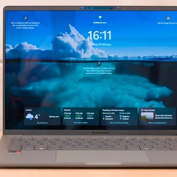 The Asus Zenbook A14 pictured from the front on a wood workbench