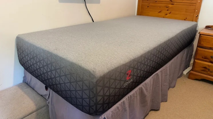 The Zoma Hybrid mattress pictured on a single bed frame