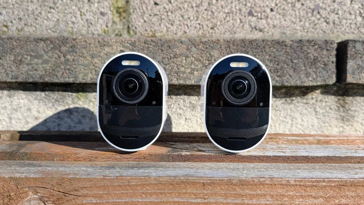 Two Arlo Ultra 3 security cameras pictured from the front