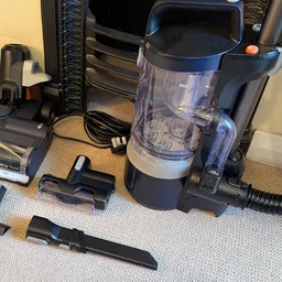 The Vax LiftOut Multi Pet Design Upright Vacuum and its attachments, laid out on the floor