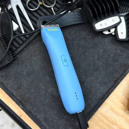 The Wahl Peanut Li trimmer charging on a barber's worktop