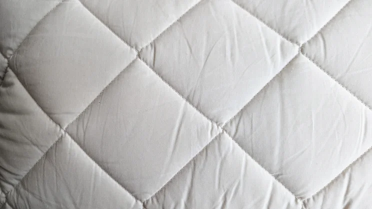 A bird's eye close up of the Woolroom Deluxe Washable Wool Pillow's quilted surface