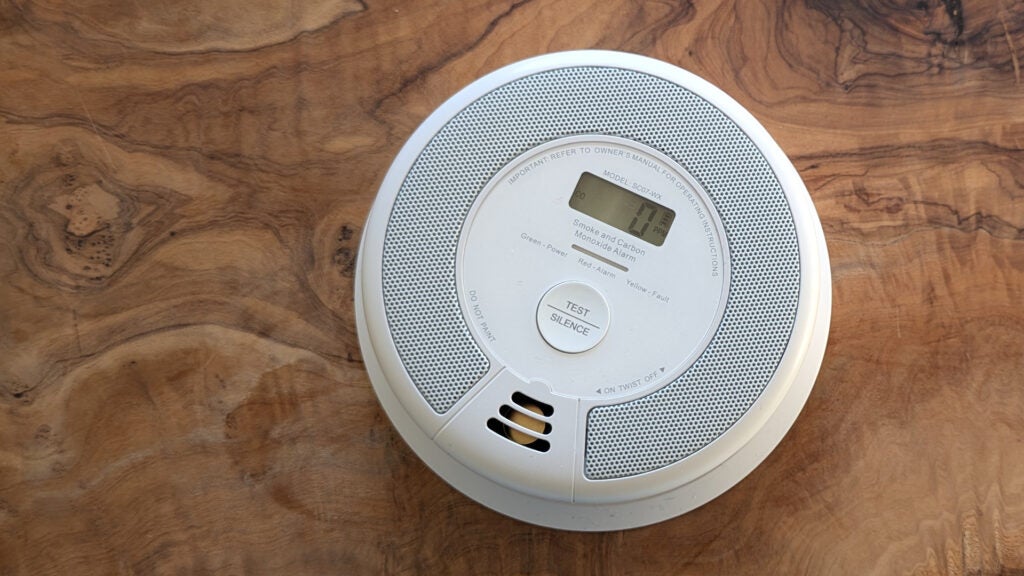 The X-Sense SC07 smoke alarm pictured from above on a wood table