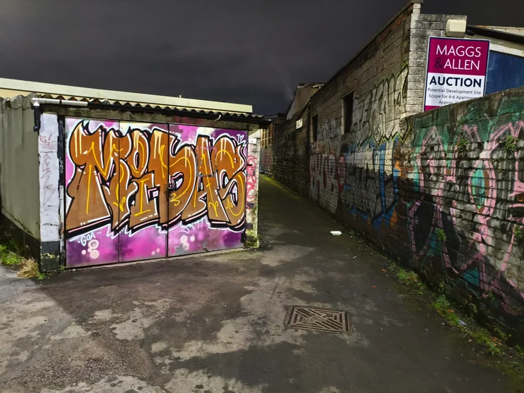 Graffiti-covered walls at night