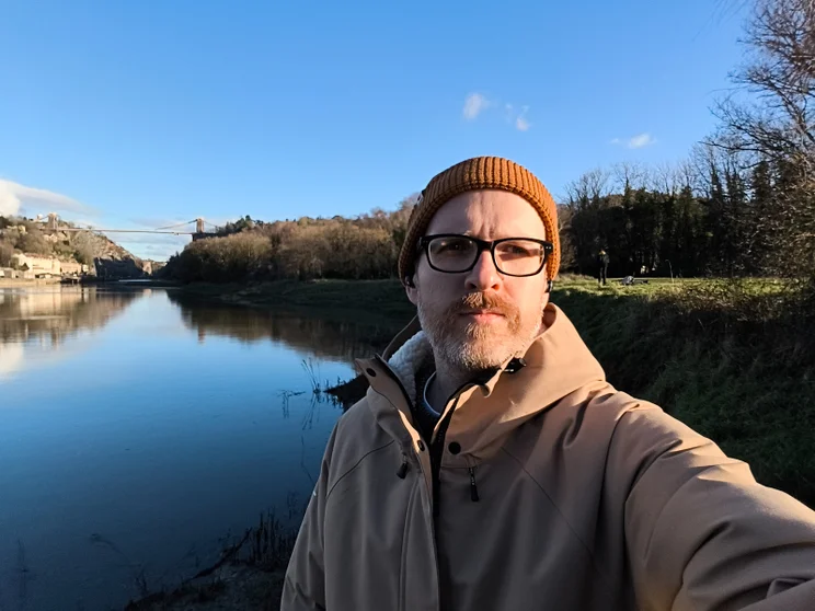 Selfie of author Jon Mundy in front of a river on a sunny day