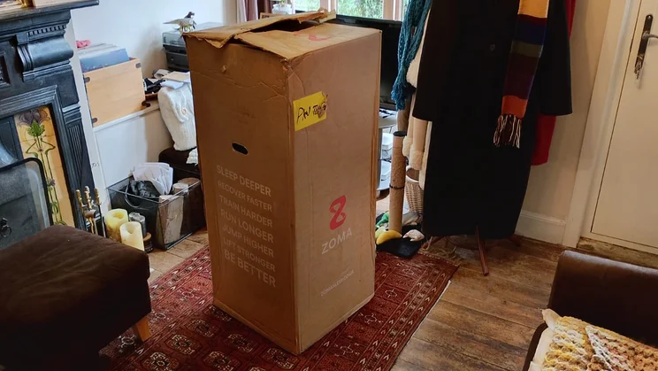 The Zoma Hybrid mattress in its box